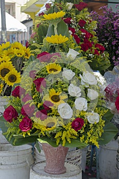 Arrangement of roses in a basket placed in market stall