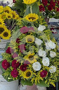 Arrangement of roses in a basket placed in market stall