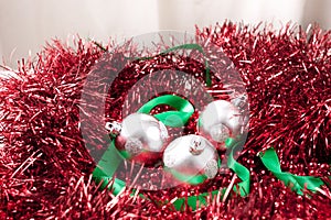 Arrangement of Silver Christmas Ornaments and Ribbon on Garland