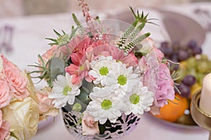 Arrangement for table with flowers and fruits