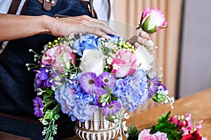 Arranging artificial flowers vest decoration at home, Young woman florist work making organizing diy artificial flower, craft and