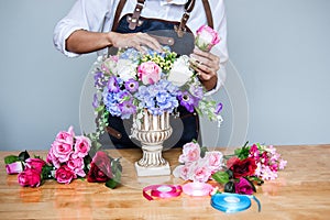 Arranging artificial flowers vest decoration at home, Young woman florist work making organizing diy artificial flower, craft and