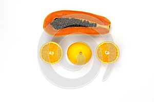 Arranging of Juicy Oranges cut isolated and a piece of papaya sliced arranged in the center of white background, Healthy fruits