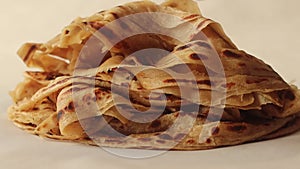 Arranging the layered Parotta or Porotta on to a plate