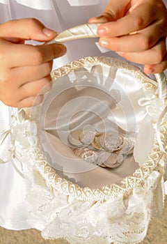 Arras, close up view of pesetas, old Spanish coins that are used symbolically in the celebration of a religious wedding in Spain.