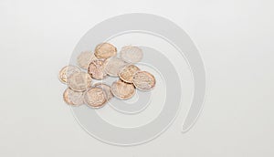 Arras, coins for weddings. Silver and copper coins with religious words in texture on white textile background.
