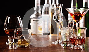 Array of alcoholic beverages in glasses at a bar