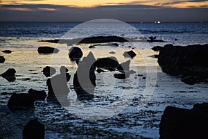 An array of beach rock silhouettes at Brighton Beach, VIC, Australia