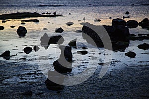 An array of beach rock silhouettes at Brighton Beach, VIC, Australia