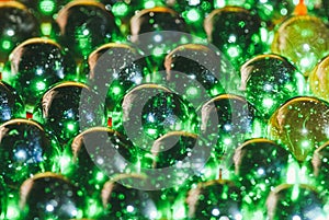 An array of green glass balls covered with dust and chips from old age