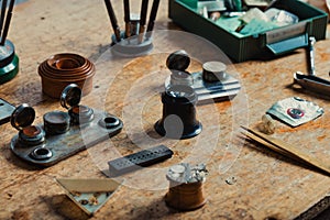 Array of precision tools and components on a watchmakers bench