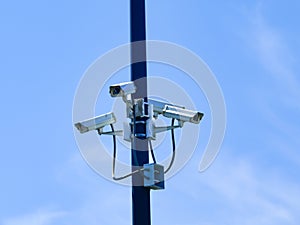 Array of security cameras in a parking lot.
