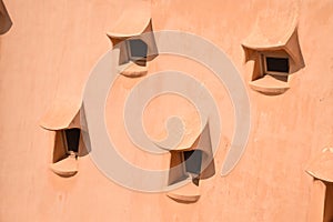 Array of small windows on an organic textured roof