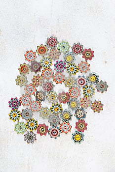 Array of vibrant colored ornamental buttons artfully arranged against a white background
