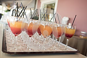 An array of wine glasses with sangria await thirsty guests at a