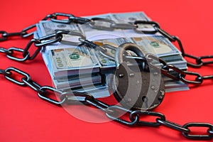 Arrest of bank account or buiness safety and financial protection concept with chain, padlock and dollars