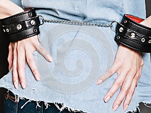 Arrest and jail. Closeup handcuffs on female hands