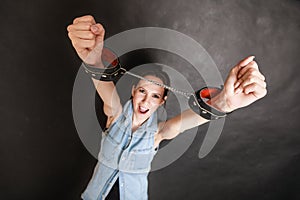 Arrest and jail. Criminal woman prisoner girl in handcuffs