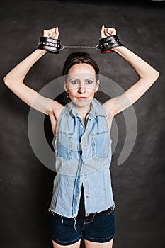 Arrest and jail. Criminal woman prisoner girl in handcuffs