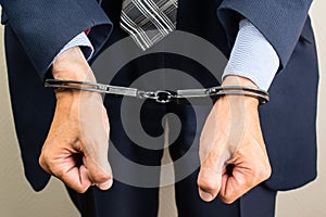 arrested businessman in handcuffs. Businessman bribetaker or bri