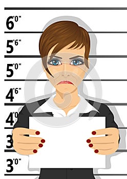 Arrested businesswoman posing for mugshot holding a signboard