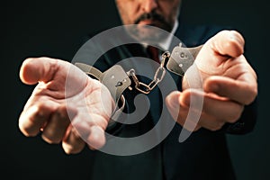 Arrested corrupted politician with handcuffs, closeup