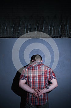 Arrested criminal male on blue background