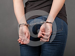 arrested girl in handcuffs, woman convicted of a crime. photo