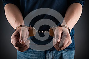 Arrested man in handcuffs with hands