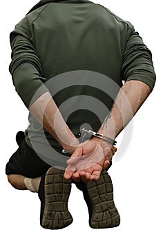 Arrested man in handcuffs in a park