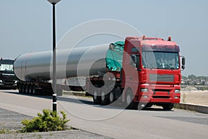 Arrival of two heavy trucks transporting masts for the construction of the wind turbine in the city of the sun