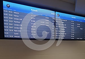 Arrivals display board at airport terminal showing international destinations flights to some of the world`s most popular cities