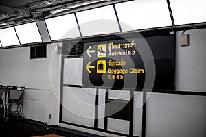 Arrivals signs and baggage claim in airport