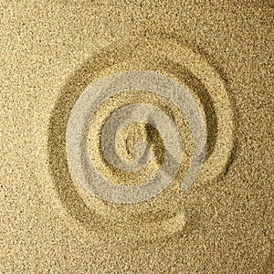 Arroba handwritten in the sand photo