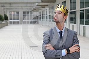 Arrogant businessman with a crown in office space