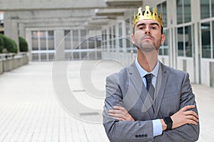 Arrogant businessman with a crown in office space