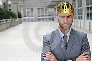 Arrogant businessman with a crown in office space