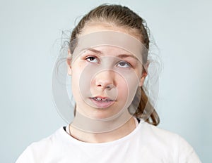 Arrogant facial expression, pre-teen Caucasian girl rolled her eyes, background, emotions series