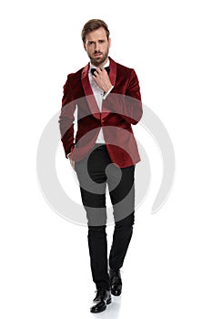 Arrogant fashion model wearing red velvet tuxedo