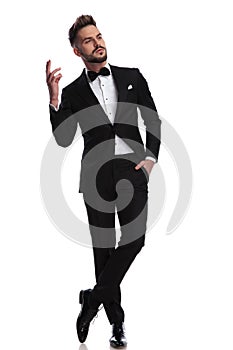 Arrogant man in tuxedo is gesturing