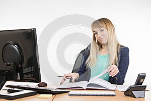 Arrogant office a specialist office leafing through a book and looking at the frame