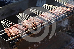 Arrosticini are a class of traditional dishes of skewered grilled meat typical of Abbruzzo and Molise regions in Italy photo