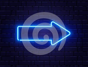 Arrow blue neon on brick wall. Realistic shining signboard. Glowing arrow pointer icon. Color neon banner. Night bright