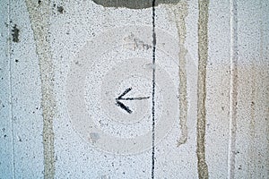 An arrow drawn with a pencil on a gas block wall close-up. The line drawn on the wall of aerated concrete bricks for builders.