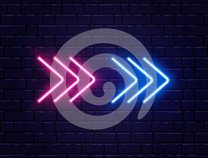 Arrow neon on brick wall. Realistic shining signboard. Glowing arrow pointers icon. Color neon banner. Night bright