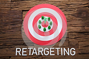 Arrow And Pawn Figurines On Dartboard With Retargeting Text photo