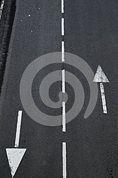 Arrow on road Indicative arrows on an asphalt road close up photo