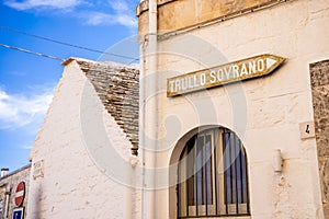 Arrow sign to the Trullo Sovrano. The Trullo Sovrano is two-story trullo house that is now a museum.