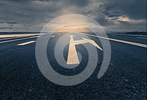 Arrow signs as road markings on a desert road