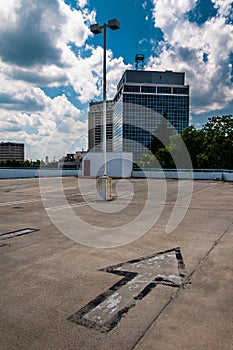 Arrow and view of highrises from a parking garage in Towson, MD photo